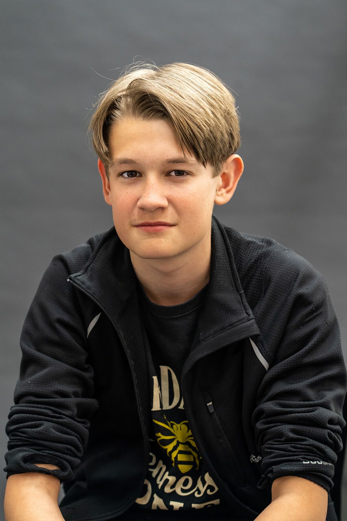 A young boy seated for a relaxed indoor portrait