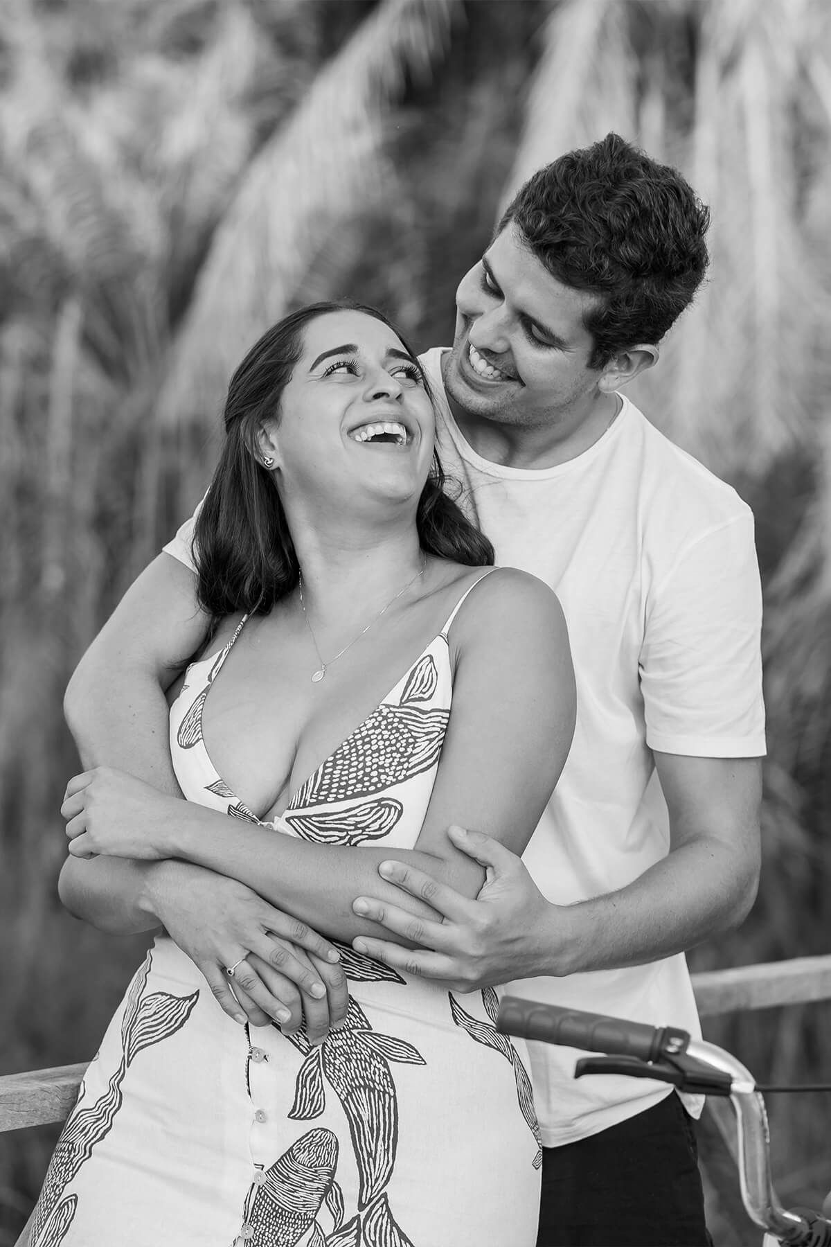 A couple embracing in a candid black-and-white portrait